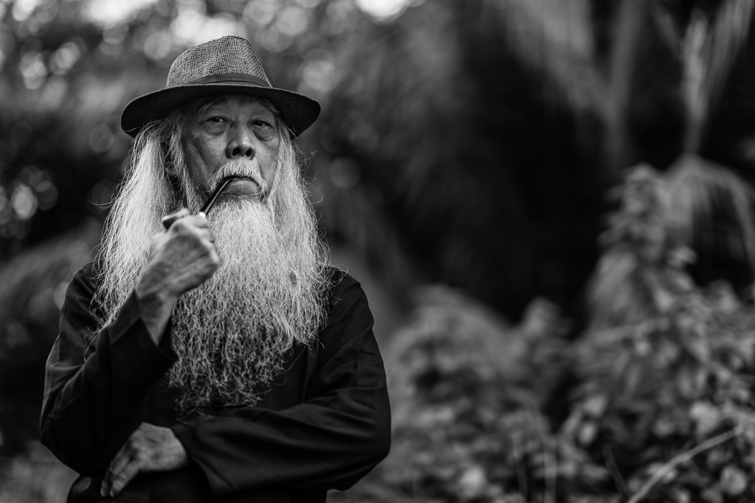 A Man Smoking A Pipe