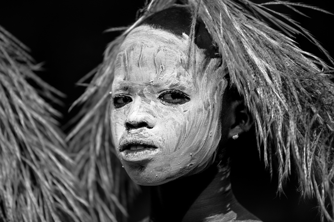 Suri boy with feathers