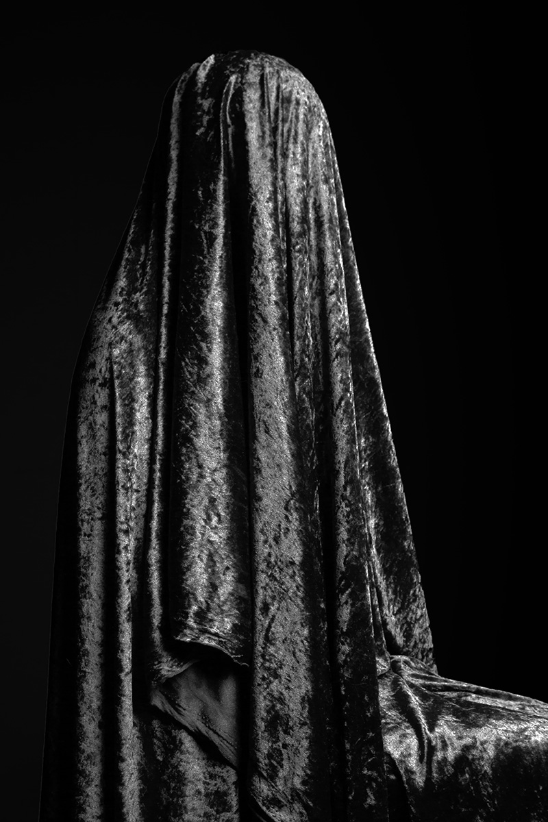 modern Madonna behind curtens
