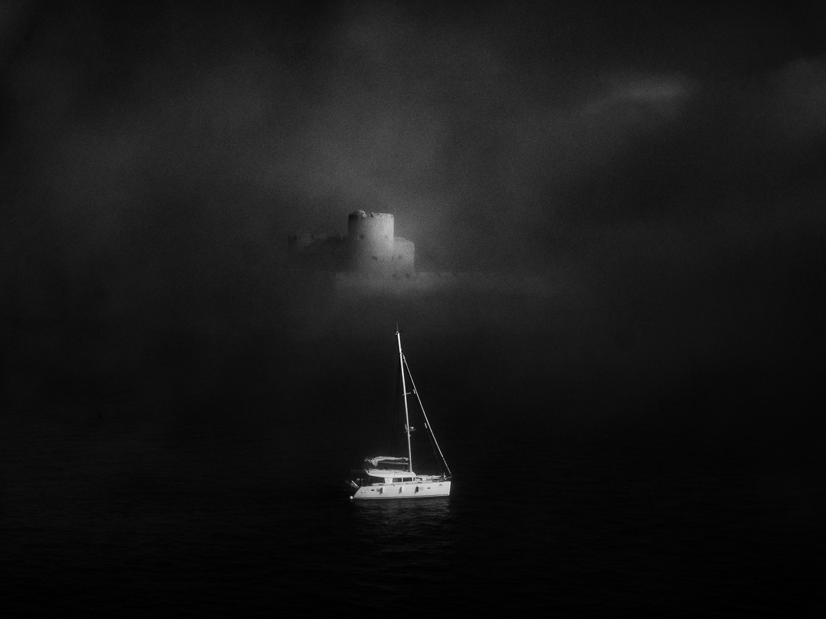 island and  sailing ship in the fog 