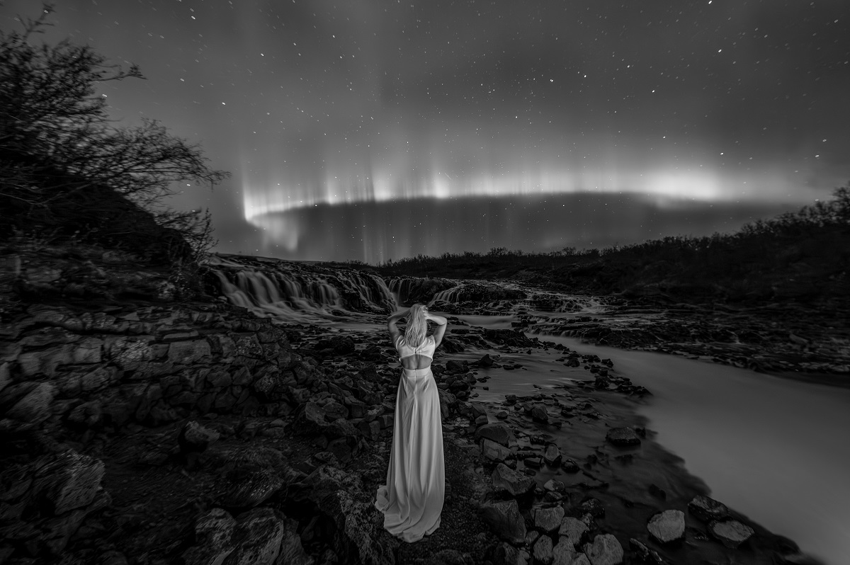 Lady Aurora over the Bruarfoss waterfall.