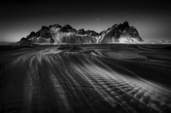 Strong winds sweep across the black sand beach at Iceland Vestrahorn